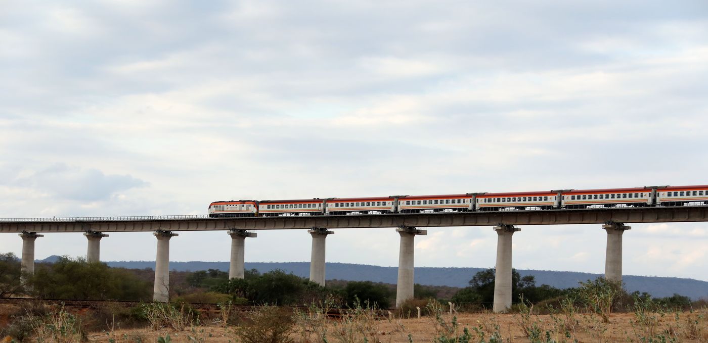 A passenger train on the Tsavo River Super Major Bridge near the Tsavo National Park in Kenya.