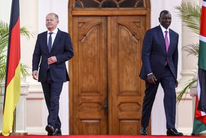 German Chancellor Olaf Scholz (L) and Kenyan President William Ruto (R) walk to their podiums for a joint press conference after holding bilateral talks at the State House in Nairobi, Kenya, May 2023.