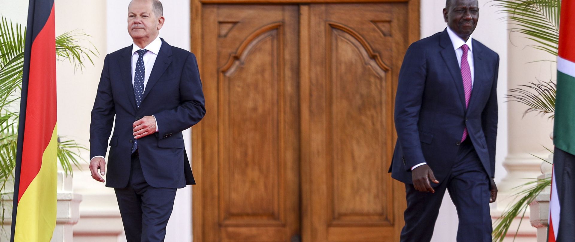 German Chancellor Olaf Scholz (L) and Kenyan President William Ruto (R) walk to their podiums for a joint press conference after holding bilateral talks at the State House in Nairobi, Kenya, May 2023.