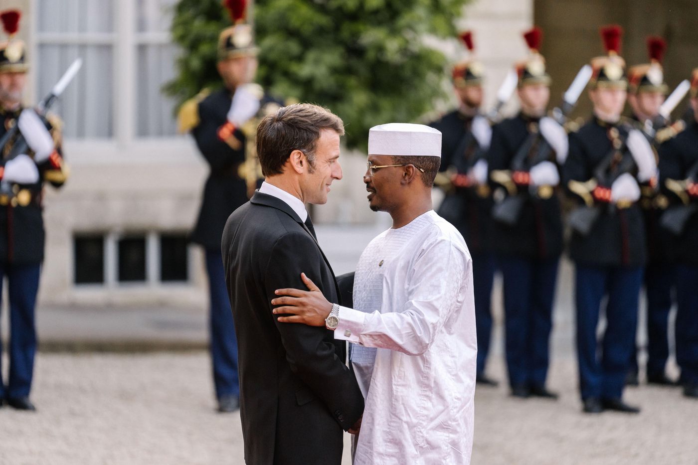 French President Emmanuel Macron greets Interim President Mahamat Idriss Deby ahead of a dinner at Élysée Palace. 