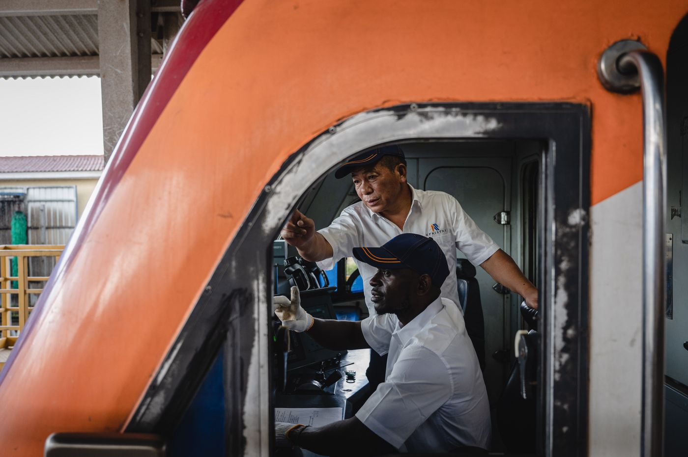 Chinese train instructor Jiang Liping (back) works with apprentice Horace Owiti in Nairobi, Kenya, May 23, 2023. 